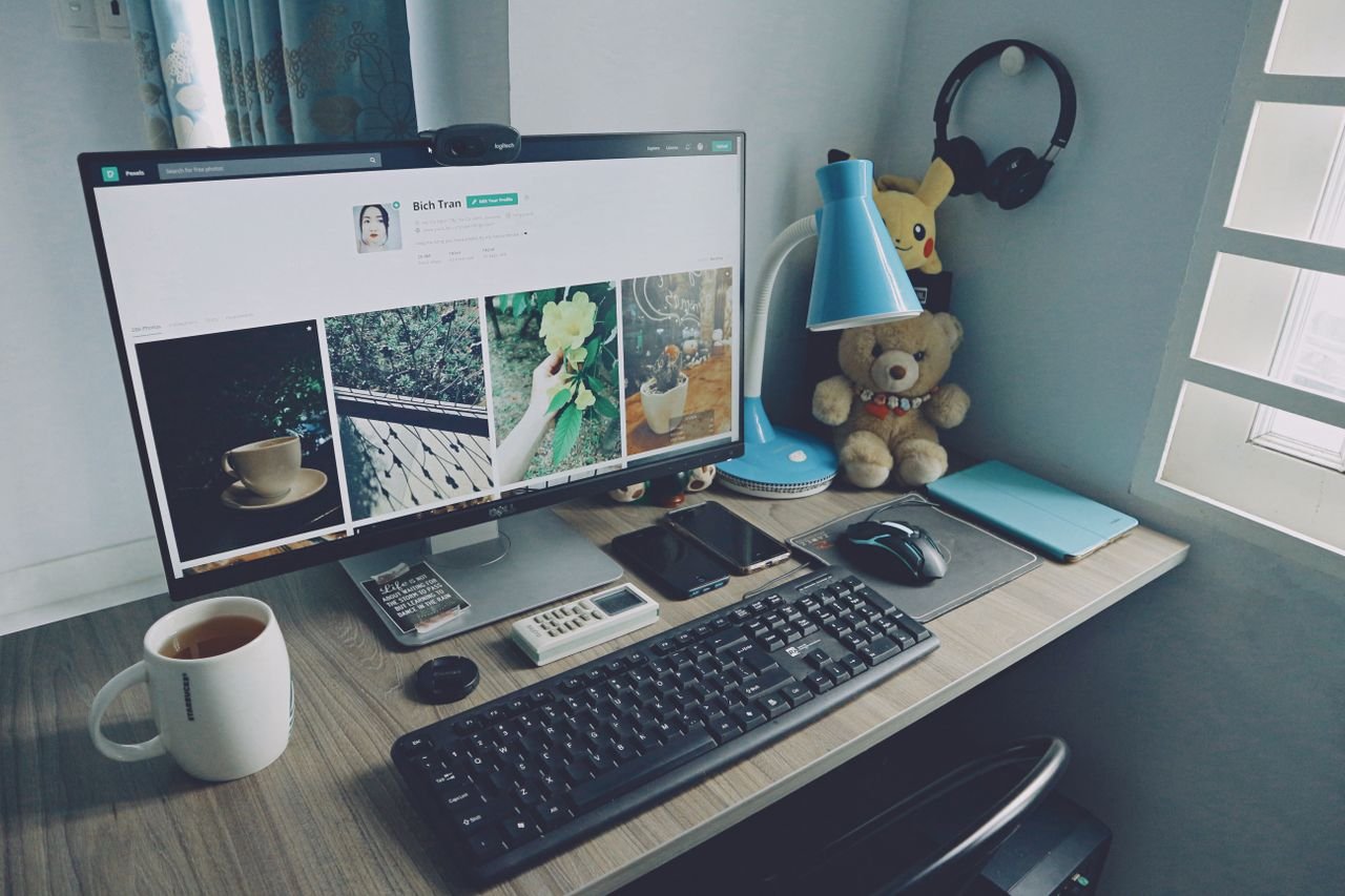 About A tidy home office desk setup with a computer, keyboard, and personal items, creating a cozy work atmosphere.