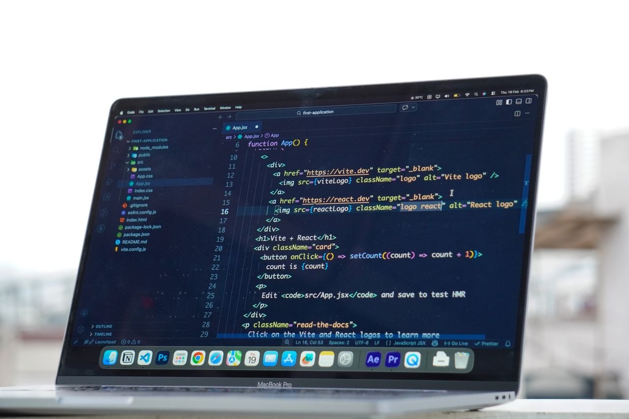 Contact Coding on a laptop outdoors, showcasing a rooftop urban lifestyle in Surat, India.