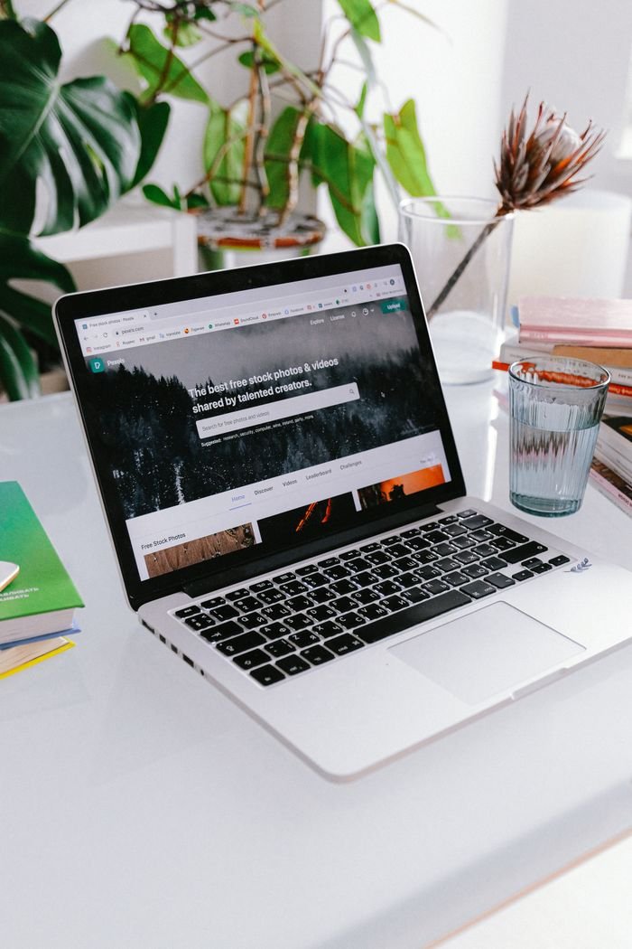 Mastering the First Impression: Your intriguing post title goes here A stylish home office setup featuring a laptop on a desk surrounded by plants, capturing a calm work-from-home vibe.